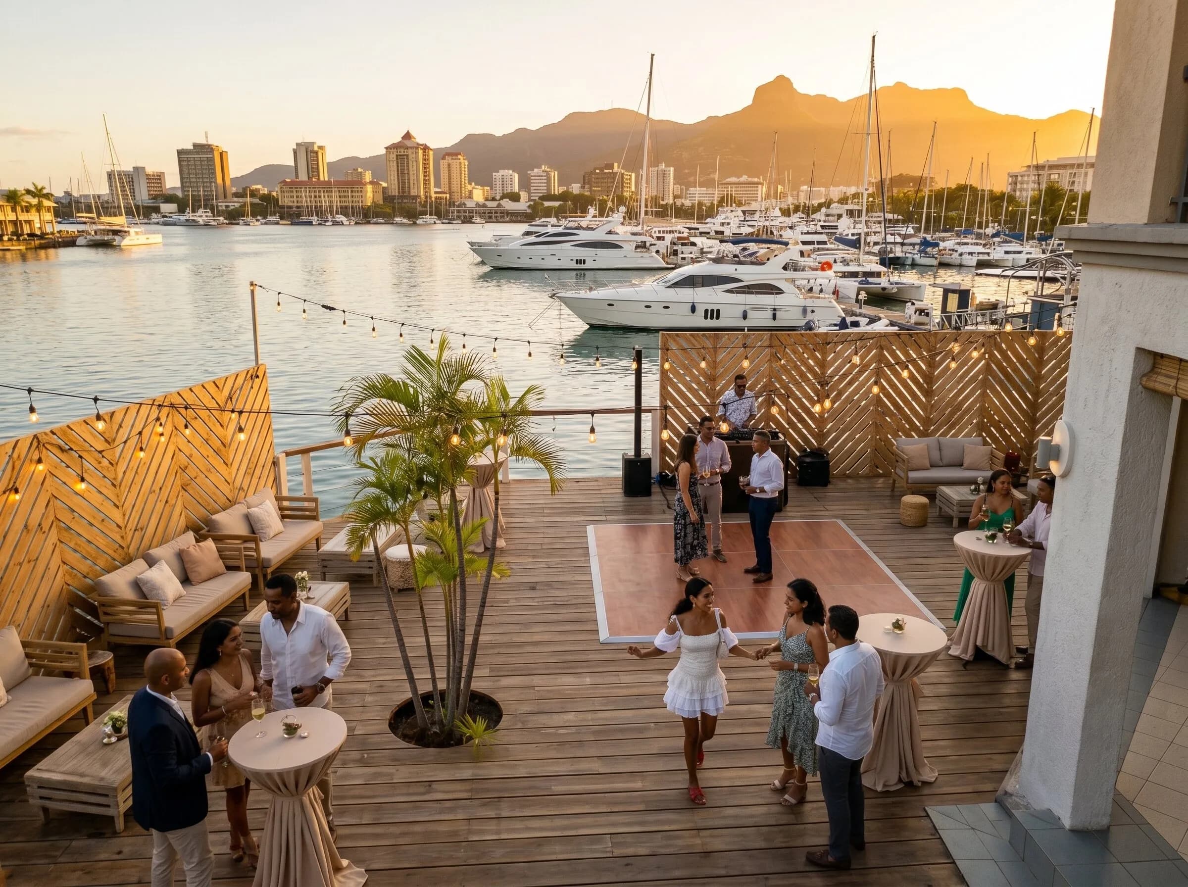 The Open Deck under string lights with the marina behind